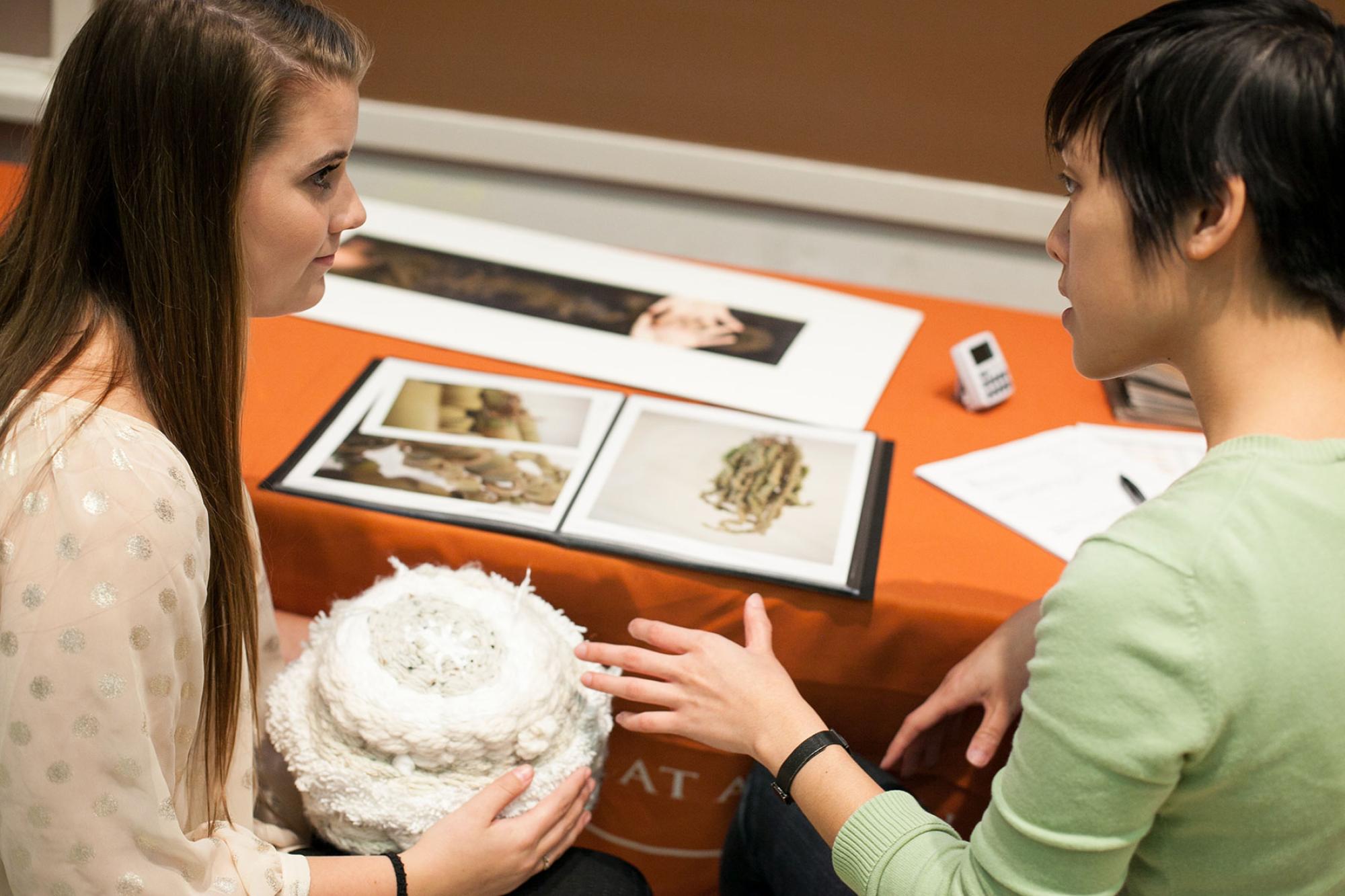 student and reviewer at table during portfolio review event