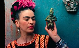 Frida Kalho holding a small sculpture
