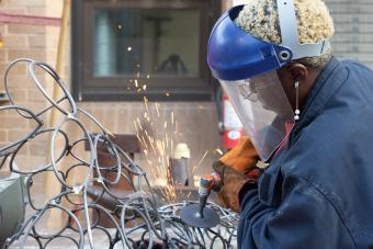 student welding metal