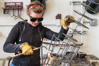 student welding in sculpture lab
