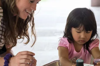 student teacher working with young child