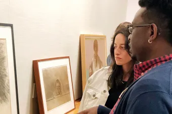 students looking at prints in museum