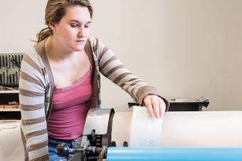 student using printing press