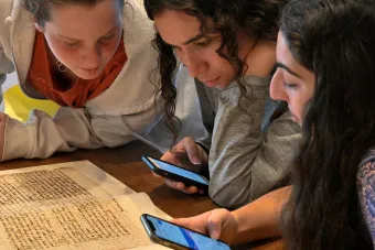 three people looking at books