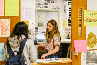 students discussing prints at the Riso Room