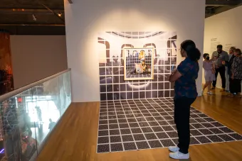 person looking at artwork in gallery space