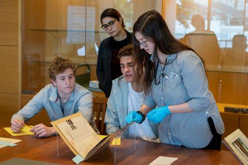 students reviewing historical book