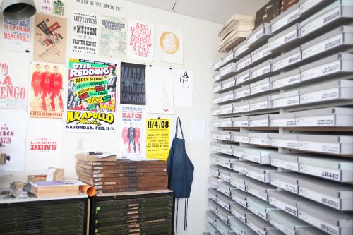 Rob Roy Kelly wood type specimins in printing studio with posters on wall