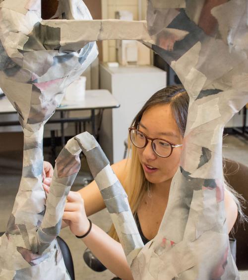 student working on sculpture