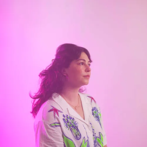 headshot in front of a pink background