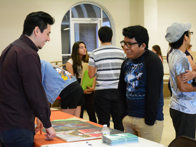 student and reviewer speaking at a portfolio review event