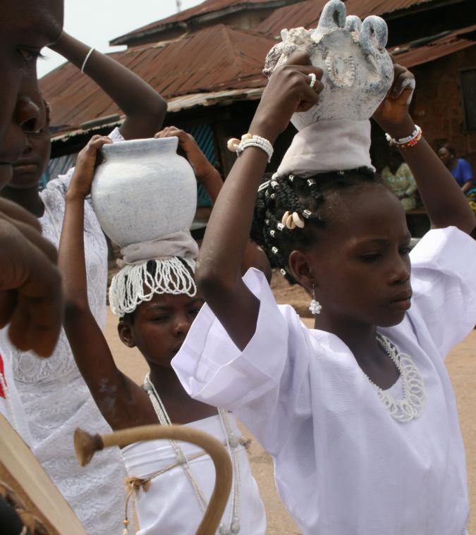 woman carrying jugs on their heads