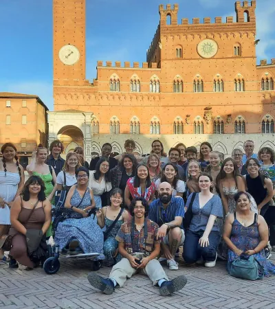 group photo of people in piazzo in Italy