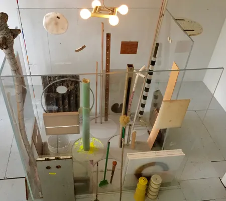 A square enclosure made of plexiglass surrounds various objects including tubes