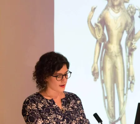 young woman at lecture podium speaking