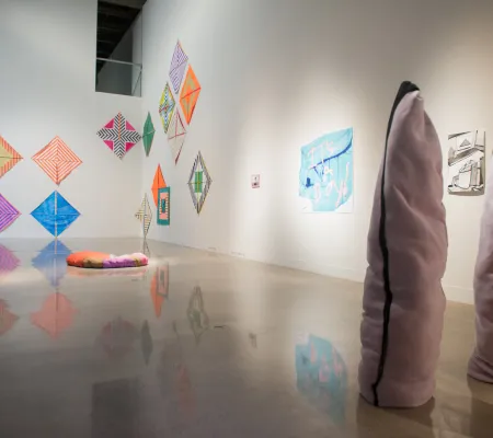 image of vaulted gallery with the work of three or four artists in the gallery space