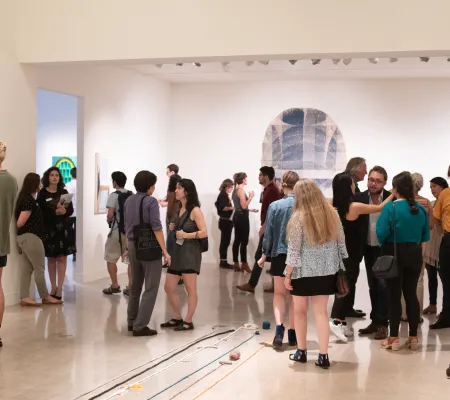 people socializing in art gallery
