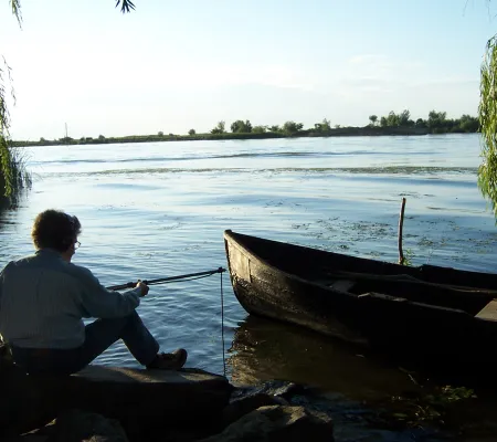 woman sitting by boat on water