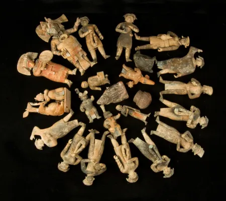 figurines arranged in concentric circles on black background