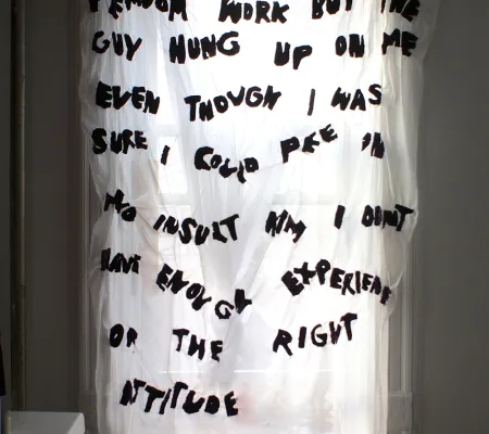 curtain with text on it hanging over a window