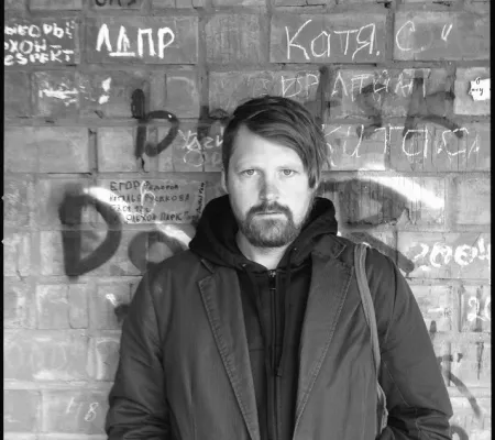 portrait of man against brick wall with graffiti