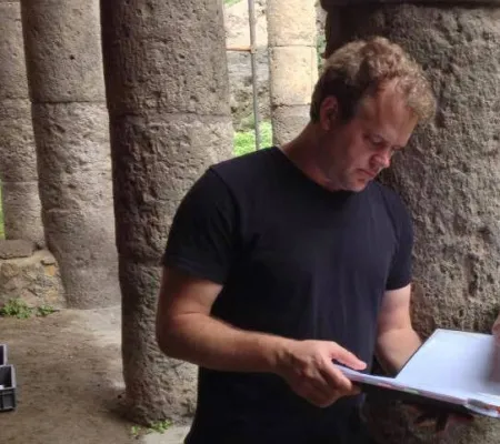 a man looking down at notebook 