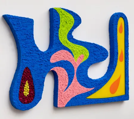 image of art piece hanging on a wall, bright colors