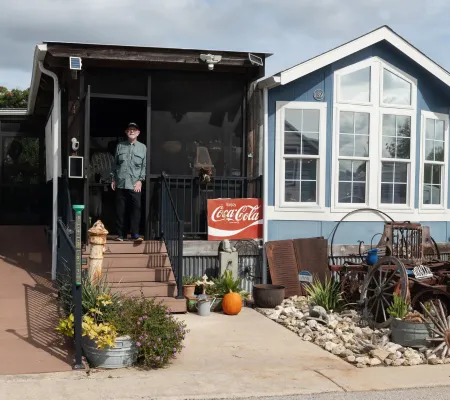 photograph of man standing outside his tiny home by Eli Durst