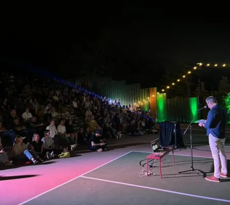 image of a person presenting to a crowd
