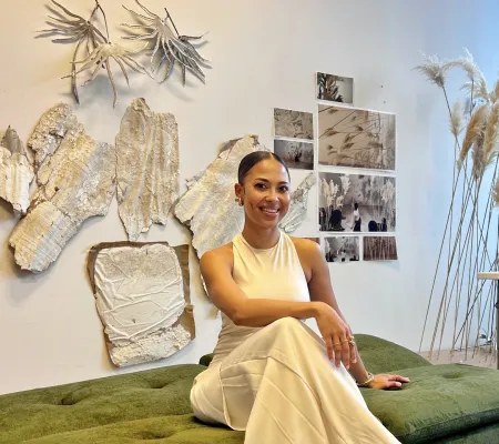Artist and St. Elmo fellow Taisha Carrington sitting in front of her work