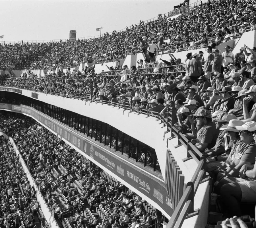 spectator crowd seated in the upper tiers of a football stadium