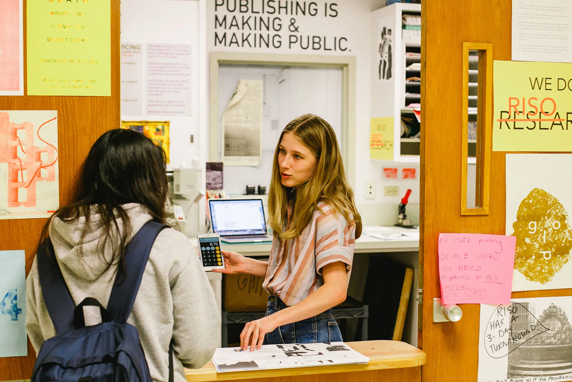 students discussing prints at the Riso Room