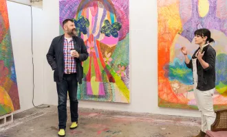 two people discussing work in studio space
