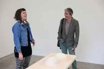 two people in front of artwork 