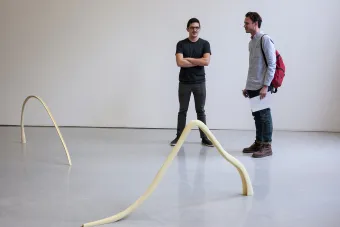 two people in front of artwork 