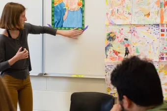student presenting artwork in class
