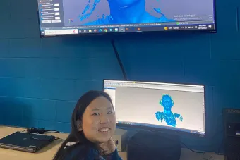 student sitting at computer in studio