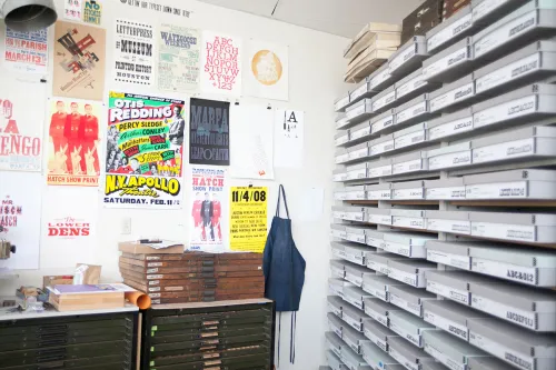 Rob Roy Kelly wood type specimins in printing studio with posters on wall