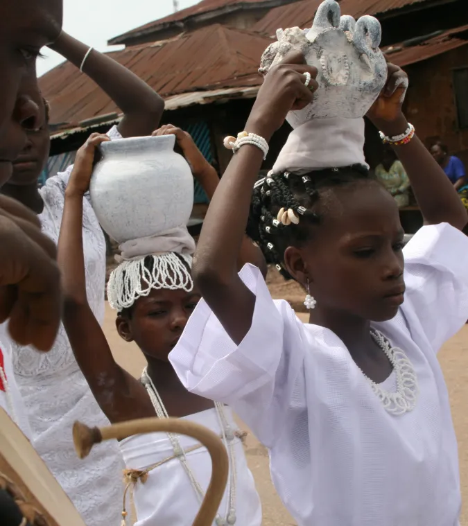 woman carrying jugs on their heads